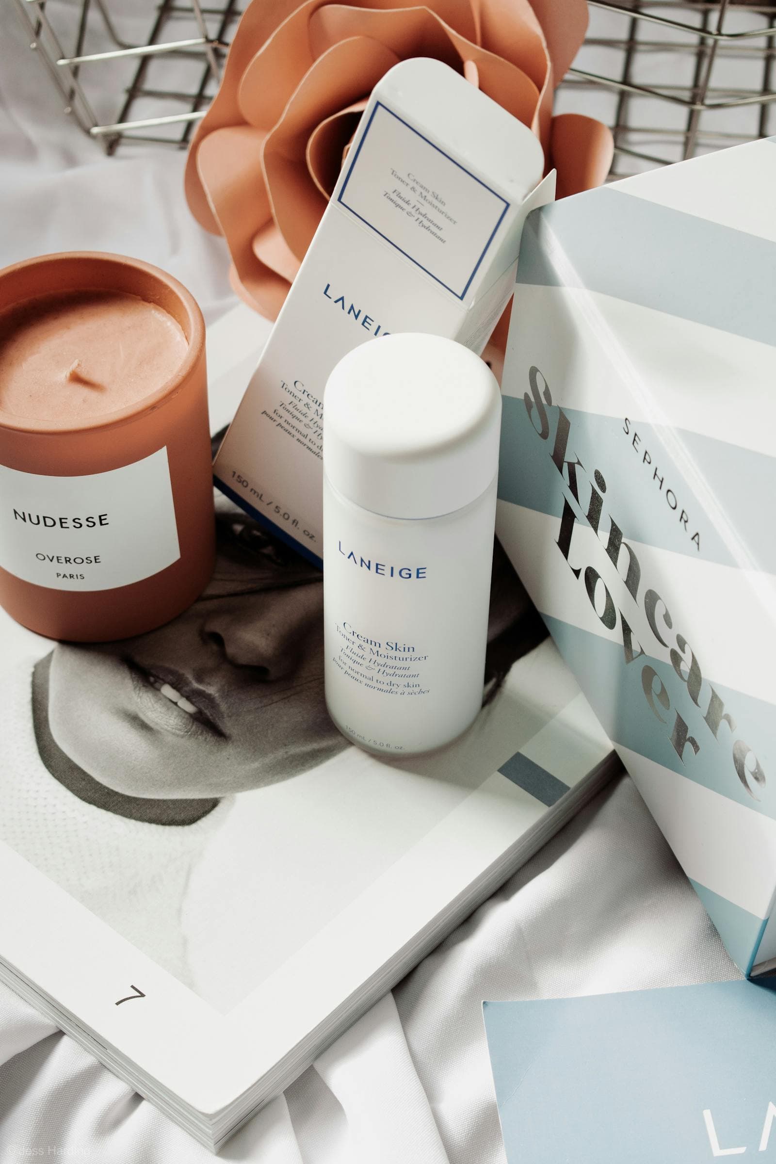 Skincare products in a warm flat lay arrangement.
