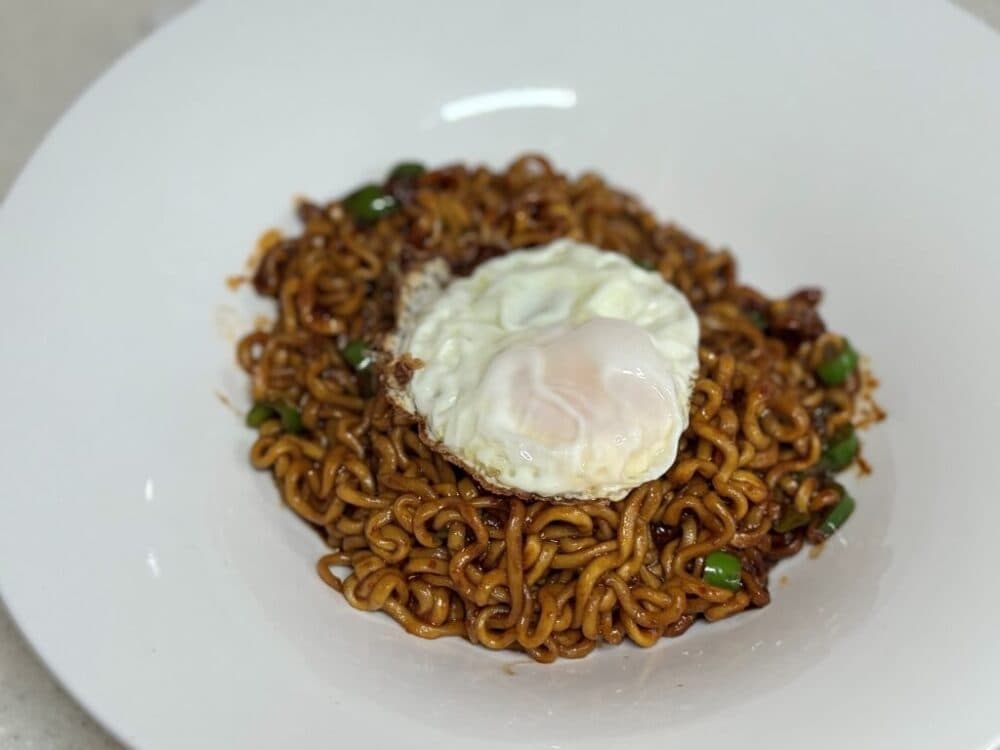 Finished bowl of spicy Chapagetti with a fried egg on top.